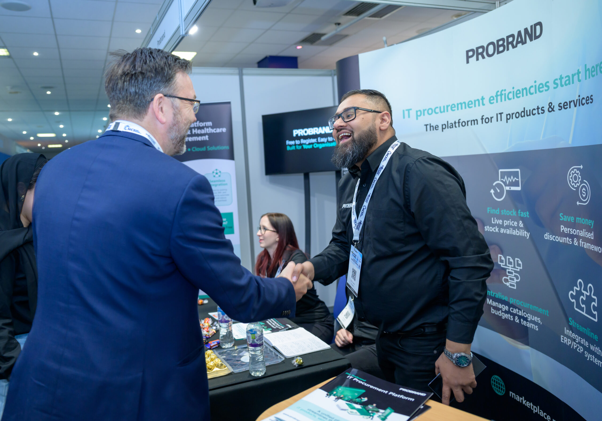 Exhibitors in conversation with delegates at a tabletop stand