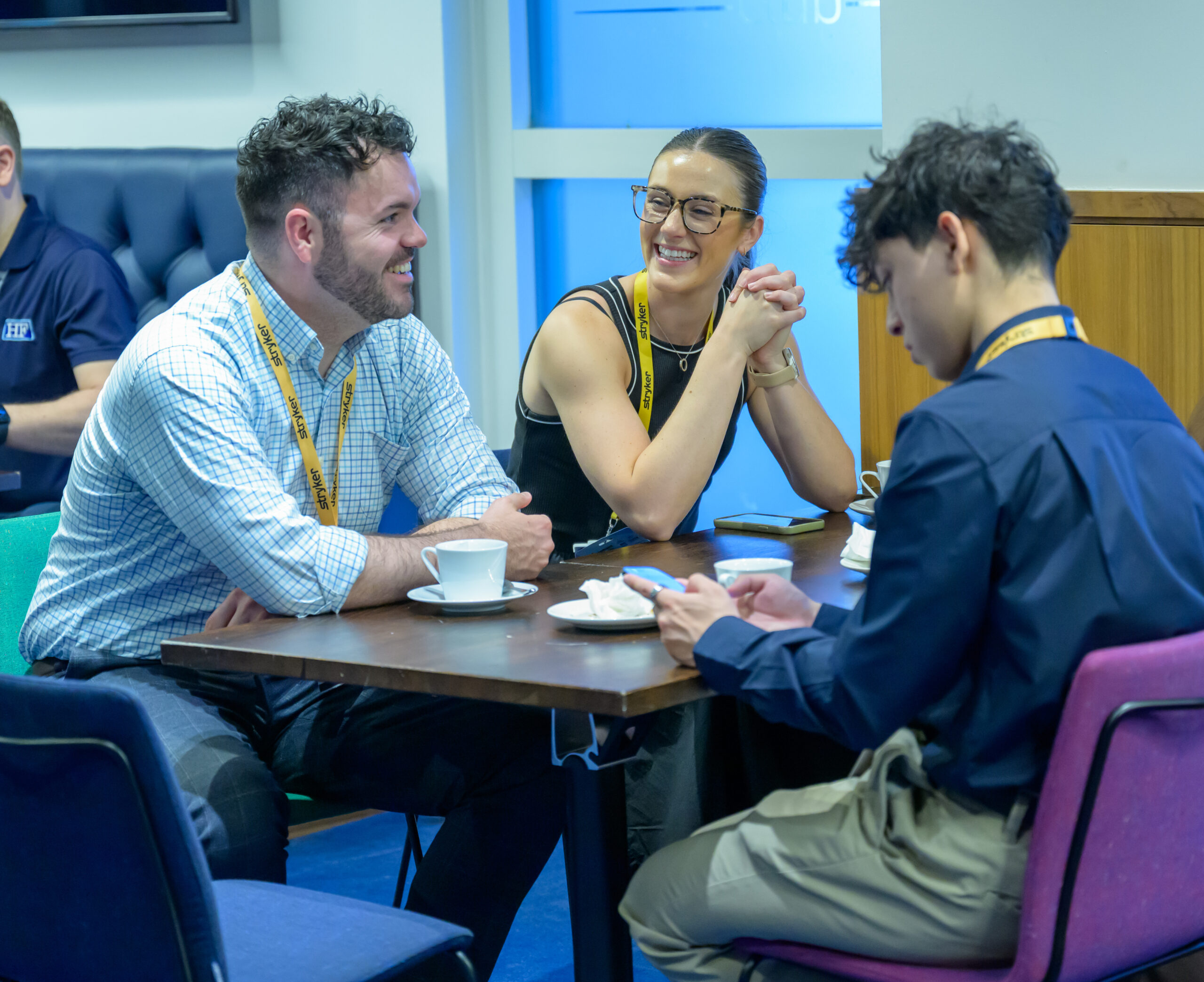 Two colleagues in conversation across a table at the event